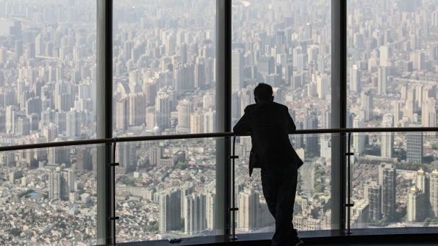 A visitor takes in the view from the observation deck at Shanghai Tower in Shanghai, China, on Sunday, April 9, 2023. China's economic recovery is picking up steam after Covid restrictions were abruptly dropped and the property market stabilizes, although the rebound is still fairly patchy and policymakers have no intention yet of scaling back monetary support. Photographer: Qilai Shen/Bloomberg