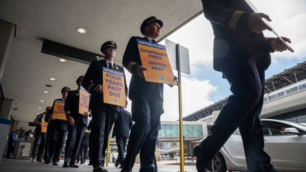 United Airlines pilots picket outside San Francisco International Airport (SFO) in San Francisco, California, US, on Friday, May 12, 2023. Thousands of United pilots, represented by the Air Line Pilots Association International (ALPA), are participating in a nationwide picket on Friday as they push for higher pay.