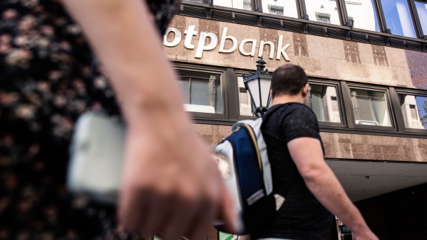 Pedestrians pass an OTP Bank Nyrt bank branch in Budapest, Hungary, on Tuesday, June 7, 2022. Inflation in Hungary exceeded 10% for the first time in more than 20 years, putting pressure on the central bank to tighten monetary policy further and prop up the forint.