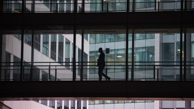 A pedestrian on an office building walkway in the La Defense business district in Paris, France, on Monday, Jan. 4, 2021. France is doing all it can to avoid a third Covid-19 lockdown, which would further hurt an economy already battered by the coronavirus pandemic, according to Budget Minister Olivier Dussopt. Photographer: Nathan Laine/Bloomberg