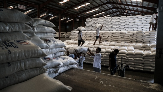 Workers unload sacks of white rice inside an National Food Authority (NFA) warehouse in Malolos town, Bulacan province, the Philippines, on Friday, July 29, 2022. Philippine President Ferdinand Marcos Jr. has asked agriculture officials to review a law that liberalized rice imports, according to a video of parts of an executive meeting posted on state media’s Facebook. Photographer: Veejay Villafranca/Bloomberg