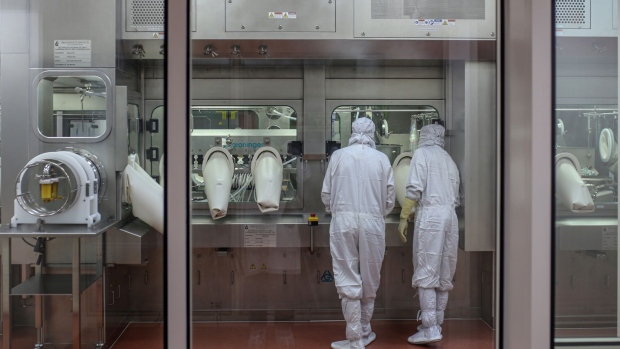 Employees monitor the production of line for Covishield, the local name for the Covid-19 vaccine developed by AstraZeneca Plc. and the University of Oxford, at the Serum Institute of India Ltd. Hadaspar plant in Pune, Maharashtra, India, on Friday, Jan. 22, 2021. Serum, which is the world's largest vaccine maker by volume, has an agreement with AstraZeneca to produce at least a billion doses.