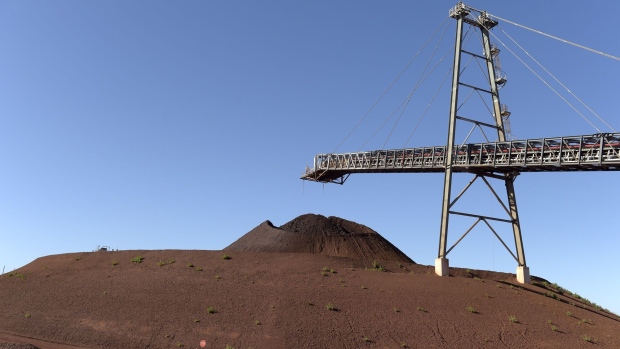 A conveyor belt transports iron ore to a stockpile at the Gudai-Darri mine operated by the Rio Tinto Group in the Pilbara region of Western Australia, Australia, on Tuesday, June 21, 2022. Gudai-Darri, with an annual capacity of 43 million tons, is expected to increase iron ore production volumes and improve product mix from the Pilbara from the second half of this year, according to a company statement. Photographer: Carla Gottgens/Bloomberg