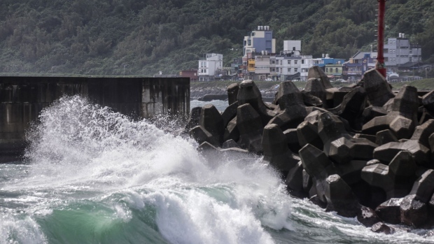 Waves generated by Typhoon Koinu break in Keelung, northern Taiwan, on Oct. 5. Photographer: I-Hwa Cheng/AFP/Getty Images