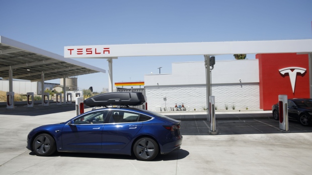A Tesla Inc. Model 3 electric vehicles departs after charging at the Tesla Supercharger station in Kettleman City, California, U.S., on Wednesday, July 31, 2019. Electric vehicles have been adopted rapidly in California, compared to the rest of the U.S., accounting for about 44% of total sales in 2018. Photographer: Patrick T. Fallon/Bloomberg