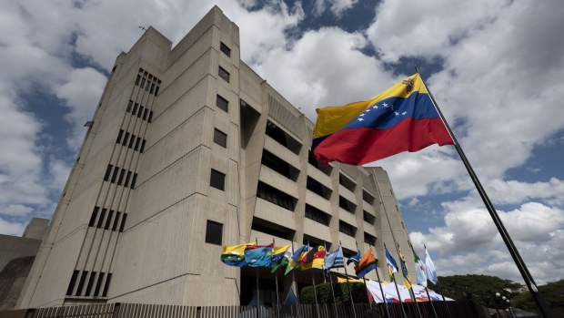 The Venezuelan flag outside the Supreme Court in Caracas, Venezuela, on Friday, Jan. 22, 2021. A dispute between the Venezuelan government and the opposition over Covid-19 antigen tests that were sent by the Pan American Health Organization is threatening to also narrow access to much-needed vaccines for the crisis-torn country. Photographer: Carlos Becerra/Bloomberg