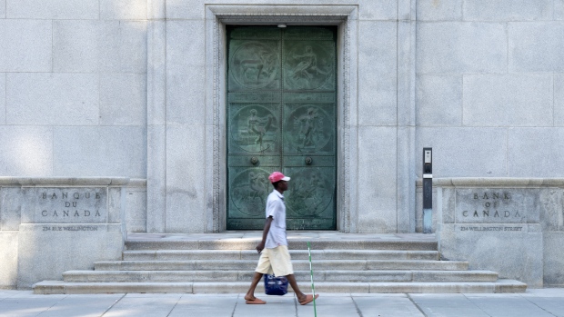 Man walking by the Bank of Canada building