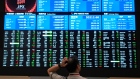 Person looking at a stock board
