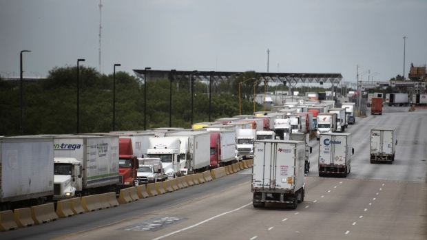 Trucks travel across the World Trade International Bridge in Laredo, Texas.