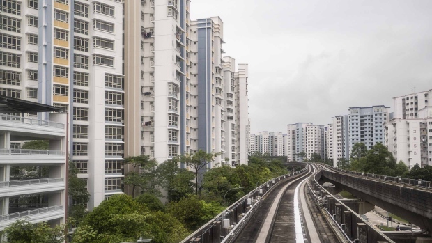 An elevated track for SMRT Corp. trains near Housing & Development Board estates in the Sengkang area of Singapore in 2021. Photographer: Ore Huiying/Bloomberg