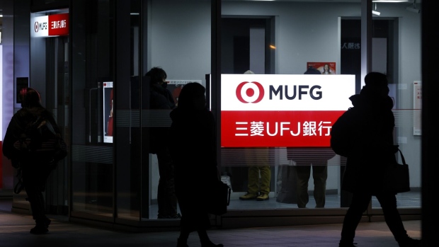 Illuminated signage for MUFG Bank Ltd., a unit of Mitsubishi UFJ Financial Group Inc. (MUFG), displayed outside a branch at night in Tokyo, Japan, on Wednesday, Jan. 25, 2023. Japan's mega banks are scheduled to release its third-quarter earnings figures next week. Photographer: Kiyoshi Ota/Bloomberg