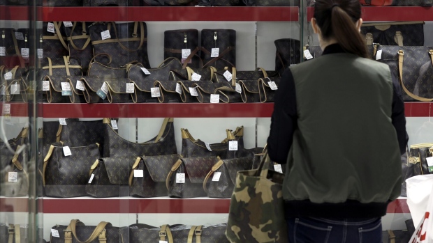 A customer looks at LVMH Moet Hennessy Louis Vuitton bags displayed in Tokyo.