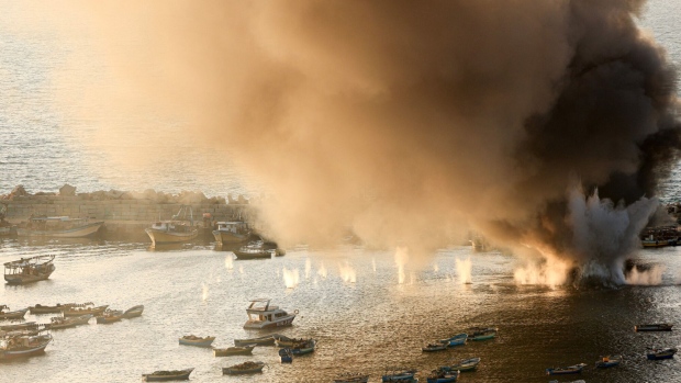 Smoke billows after a strike on the port of Gaza City on Oct. 10. Photographer: Mahmud Hams/AFP/Getty Images