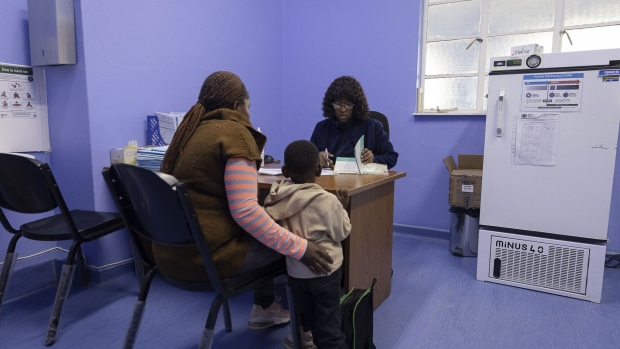 A nurse speaks with a patient in a consulting room at the Sonop Clinic, a government medical facility expanded and partially equipped by Sibanye-Stillwater Ltd., in Marikana, South Africa. Photographer: Guillem Sartorio/Bloomberg