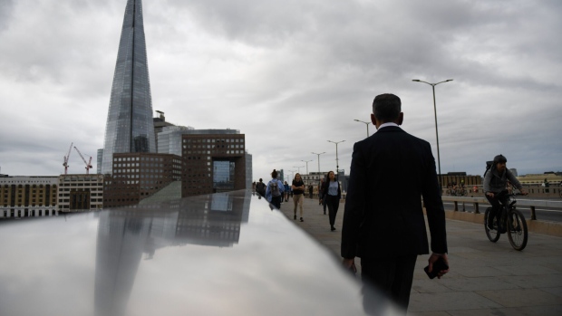 Commuters cross London Bridge in London, UK, on Tuesday, Sept. 12, 2023. UK wage growth held at a record high in the three months through July, a sign of persistent inflation that will keep pressure on the Bank of England to raise interest rates again.