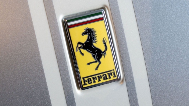 A Ferrari badge on a Ferrari Daytona SP3 luxury sports car in Maranello, Italy, on Tuesday, Feb. 7, 2023. Speaking at Ferrari’s Maranello headquarters, Ferrari Chief Executive Officer Benedetto Vigna, 53, credited Tesla with accelerating change within an industry steeped in engine cylinders. Photographer: Francesca Volpi/Bloomberg