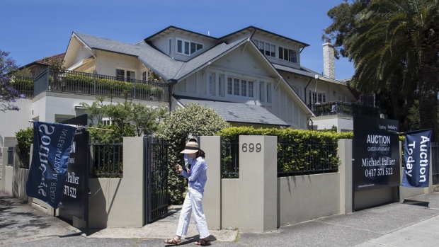 A woman outside a residential home auction in the Rose Bay area in Sydney, Australia, on Saturday, Nov. 12, 2022. Australia’s home loan values plunged 8.2% from a month earlier to A$25.1 billion ($16.1 billion), the lowest level since November 2020, according to data released by the Australian Bureau of Statistics. Photographer: Brent Lewin/Bloomberg