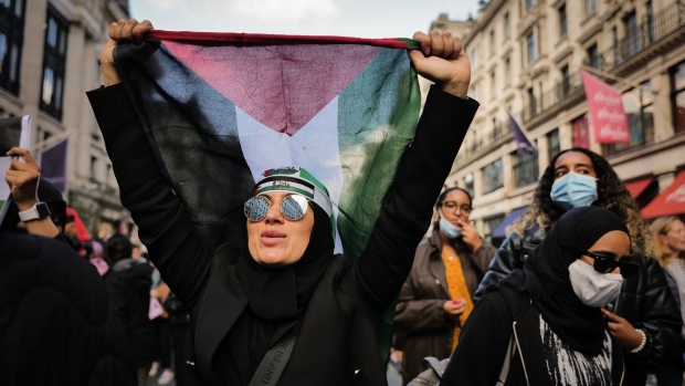 A protester carries a Palestinian flag during a pro-Palestinian demonstration in central London, on Saturday, Oct. 14. Photographer: Jose Sarmento Matos/Bloomberg