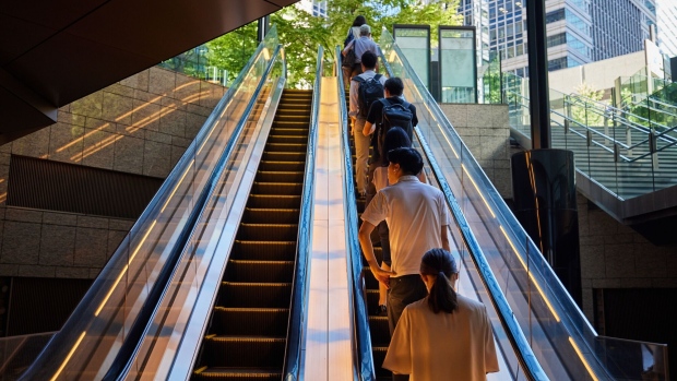 Morning commuters ride an escalator in Tokyo, Japan, on Monday, Aug. 21, 2023. Japan's ministry of internal affairs will release the country's monthly unemployment rate on Aug. 29. Photographer: Shoko Takayasu/Bloomberg
