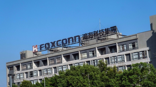 Signage atop the Hon Hai Precision Industry Co. headquarters in New Taipei City, Taiwan, on Wednesday, Aug. 10, 2022. Taiwan wants to force Foxconn Technology Group to unwind an $800 million investment in Chinese chipmaker Tsinghua Unigroup, the Financial Times reported, citing unidentified people familiar with the matter. Photographer Lam Yik Fei/Bloomberg Photographer: Lam Yik Fei/Bloomberg