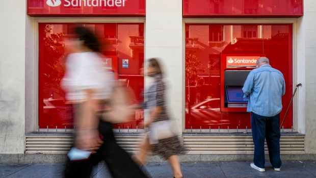 A customer uses an automated teller machine (ATM) outside a Banco Santander SA bank branch in Madrid, Spain, on Wednesday, July 26, 2023. Banco Santander’s earnings beat estimates as its domestic market became the Spanish lender’s top profit maker for the first time in more than a decade, boosted by rising interest rates. Photographer: Paul Hanna/Bloomberg