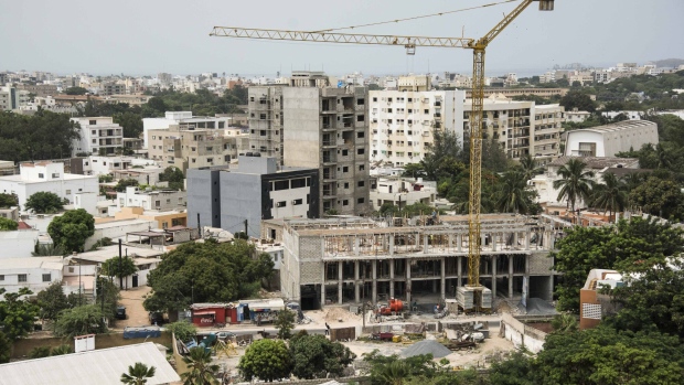 A crane stands above a building under construction in Dakar, Senegal in July 2017. 