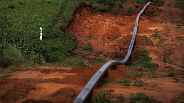 A China National Offshore Oil Corp. land boundary marker near a section of the Kingfisher Feeder Pipeline, part of the East African Crude Oil Pipeline (EACOP), in Kikuube, Uganda, on Tuesday, Oct. 24, 2023. The $4 billion EACOP infrastructure will transport 16,000 barrels of oil a day from Western Uganda to Tanzania's Tanga port on the Indian Ocean coast.