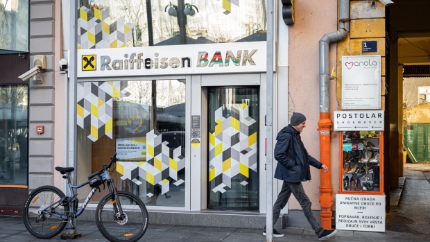 A pedestrian passes a branch of Raiffeisen Bank International AG in Zagreb, Croatia, on Monday, Jan. 2, 2023. Croatia joined the euro zone and the European Union's visa-free travel area on Jan. 1, completing its journey from the war-torn Balkans to the European mainstream.