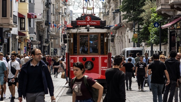 Shoppers and trams on Istiklal Street in Istanbul, Turkey, on Thursday, June 8, 2023. Turkey's lira plunged to a record low as state-run lenders temporarily halted dollar sales, in a sign the new economic team is abandoning a costly intervention strategy as part of an expected turn toward more conventional policies.