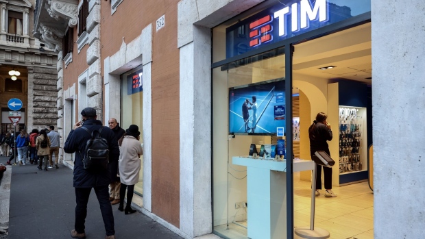 Pedestrians pass a Telecom Italia SpA store in Rome, Italy, on Tuesday, March 7, 2023. Italy’s state lender kicked off a bidding war with US-based KKR & Co Inc., launching a counterbid for Telecom Italia SpA’s €20 billion ($21.3 billion) landline network.