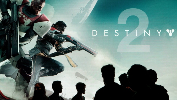 Attendees walk past signage for the Activision Blizzard Inc. "Destiny 2" video game, developed by Bungie Inc., during the E3 Electronic Entertainment Expo in Los Angeles, California, U.S., on Wednesday, June 14, 2017. For three days, leading-edge companies, groundbreaking new technologies and never-before-seen products is showcased at E3.