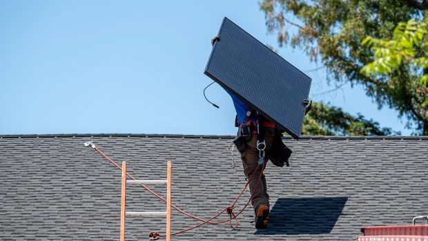 Workers install solar panels during a SunPower installation on a home in Napa, California, US, on Monday, July 17, 2023. SunPower Corp. is scheduled to release earnings figures on August 1. Photographer: David Paul Morris/Bloomberg