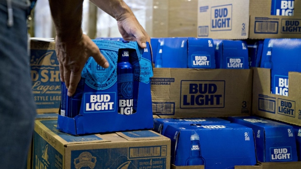 An employee adjusts bottles of Bud Light brand beer at an Anheuser-Busch InBev NV facility during a campaign stop by Senator Tim Kaine, a Democrat from Virginia, not pictured, in Williamsburg, Virginia, U.S., on Wednesday, Aug. 8, 2018. Kaine will face Republican opponent Corey Stewart in the November midterm elections. Photographer: Andrew Harrer/Bloomberg