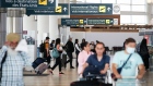 Passengers and signage at Winnipeg airport