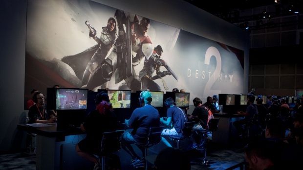 Attendees play the "Destiny 2" video game developed by Bungie Inc. and published by Activision Blizzard Inc. during the E3 Electronic Entertainment Expo in Los Angeles, California, U.S., on Tuesday, June 13, 2017. For three days, leading-edge companies, groundbreaking new technologies and never-before-seen products is showcased at E3. Photographer: Troy Harvey/Bloomberg 