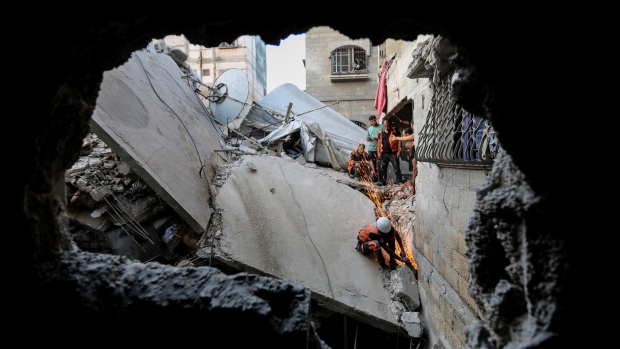People search through destroyed buildings in Khan Yunis, Gaza on Nov. 1.