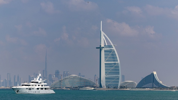 A luxury yacht moored in front of the Burj Al Arab hotel in Dubai.