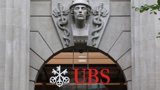 A logo above the entrance to the UBS Group AG headquarters in Zurich, Switzerland, on Thursday, Aug. 31, 2023. UBS posted the biggest-ever quarterly profit for a bank in the second quarter as a result of its emergency takeover of Credit Suisse, and confirmed that it would fully integrate the local business of its former rival by next year.