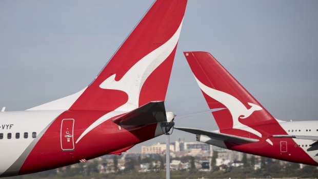 The Qantas Airways Ltd. logos displayed on aircraft tails at Sydney Airport in Sydney, Australia, on Tuesday, August 22, 2023. Qantas is scheduled to release earnings results on Aug. 24. Photographer Brent Lewin/Bloomberg Photographer: Brent Lewin/Bloomberg