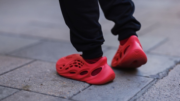 LONDON, ENGLAND - SEPTEMBER 17: A fashion week guest seen wearing red adidas yeezy shoes, outside paul and joe during London Fashion Week September 2022 on September 17, 2022 in London, England. (Photo by Jeremy Moeller/Getty Images)
