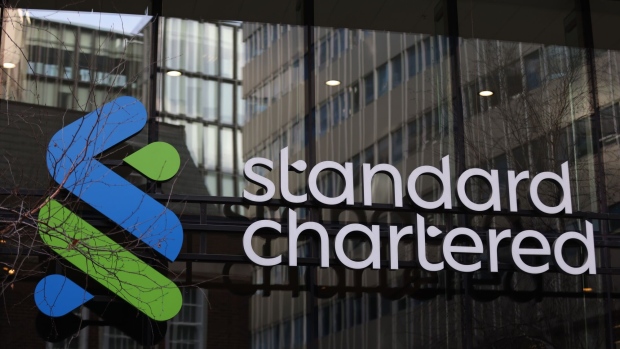 A Standard Chartered Plc logo at their headquarters in London, UK, on Thursday, Feb. 9, 2023. First Abu Dhabi Bank PJSC is pressing ahead with a potential offer for Standard Chartered Plc, after a move to put earlier takeover plans on hold didn’t halt its ambitions to become a global financial powerhouse.