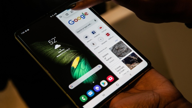 An attendee uses a Samsung Electronics Co. Galaxy Fold mobile device during an unveiling event in New York, U.S., on Monday, April 15, 2019. Samsung announced the phone in February and it goes on sale April 26 at the wallet-stretching price of $1,980.