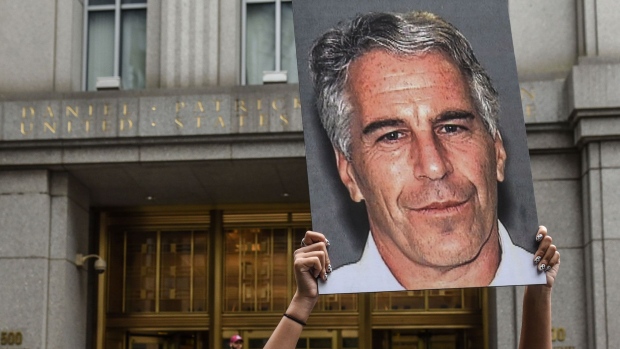 A protest group called "Hot Mess" hold up signs of Jeffrey Epstein in front of the federal courthouse in New York in 2019. Photographer: Stephanie Keith