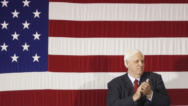 Jim Justice, governor of West Virginia, applauds on stage before participating in a round table discussion on tax reform with U.S. President Donald Trump, not pictured, at the White Sulphur Springs Civic Center in White Sulphur Springs, West Virginia, U.S., on Thursday, April 5, 2018. Trump revisited remarks he made about Mexican "rapists" crossing the U.S. border when he announced his run for president and assailed the nation's immigration laws in a speech on Thursday that was supposed to focus on his tax law.
