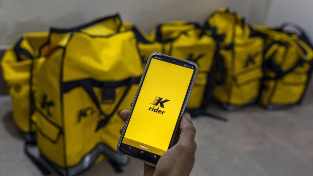 A Krave Mart delivery rider uses the company app while waiting to pick up customer orders at one of the company's dark stores in Karachi, Pakistan, on Saturday, Dec. 11, 2021. Pakistan's rapid delivery startup Krave Mart has raised the country's largest early funding to grow its business in the world’s fifth-most populous nation.