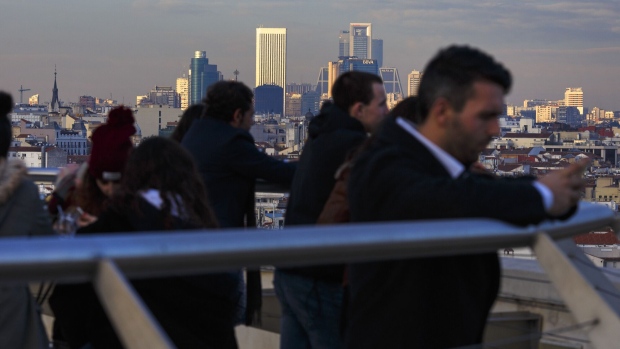 Visitors view the city skyline from the outdoor viewing area at the Circulo de Bellas Artes de Madrid (CBA) building in Madrid, Spain, on Tuesday, Dec. 27, 2016. Spanish banks and borrowers are assessing the impact of a ruling by Europe’s top court that lenders charged too much for mortgages. Photographer: Angel Navarrete/Bloomberg