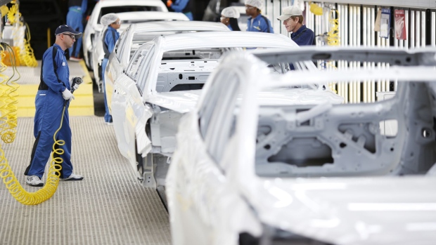 Employees inspect vehicle frames inside the Hyundai Motor Manufacturing Alabama facility in Montgomery.