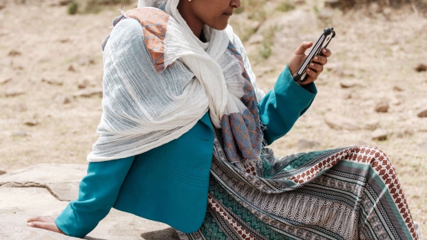 A woman uses her mobile phone in Ethiopia. Photographer: Yasuyoshi Chiba/AFP/Getty Images