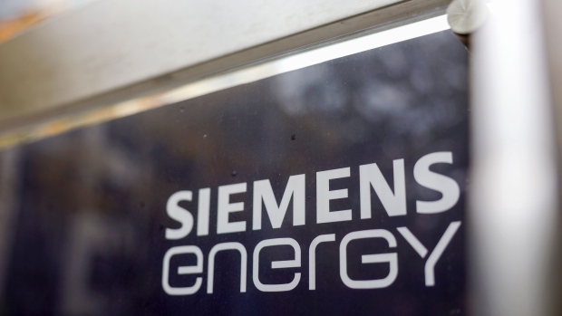 A Siemens Energy AG logo on a sign at the company's gas turbine factory in Berlin, Germany, on Friday, Oct. 27, 2023. Siemens Energy AG is in talks with the German government about securing as much as 16 billion ($16.9 billion) in state guarantees as problems at its wind-turbine unit spread to the rest of the business. Photographer: Liesa Johannssen-Koppitz/Bloomberg