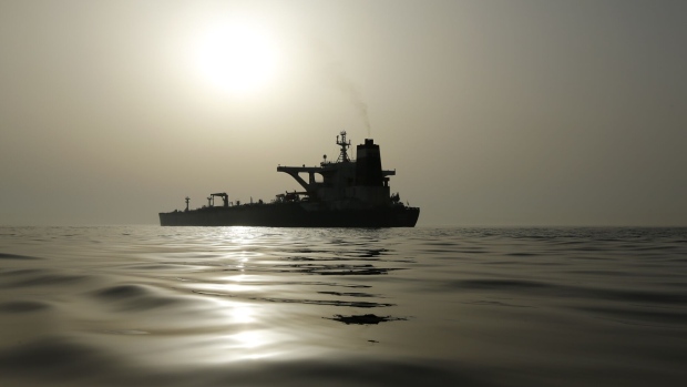 The impounded Iranian crude oil tanker, Grace 1, is silhouetted as it sits anchored off the coast of Gibraltar on Saturday, July 20, 2019. Tensions have flared in the Strait of Hormuz in recent weeks as Iran resists U.S. sanctions that are crippling its oil exports and lashes out after the seizure on July 4 of one of its ships near Gibraltar. Photographer: Marcelo del Pozo/Bloomberg